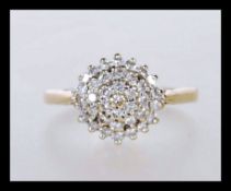 A hallmarked 9ct gold cluster ring set with white