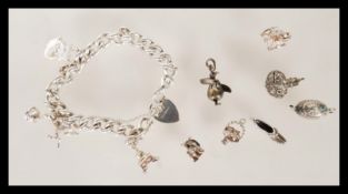 A silver hallmarked curb link bracelet having a he