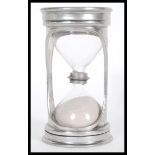 A Marinoni glass hourglass egg timer having a pewt