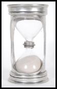 A Marinoni glass hourglass egg timer having a pewt