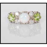 A silver ring set with a central prong set opal fl