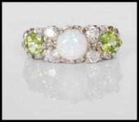 A silver ring set with a central prong set opal fl