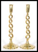 A pair of 20th Century brass candlesticks having a