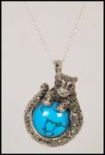A silver and marcasite pendant necklace having cen