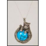 A silver and marcasite pendant necklace having cen