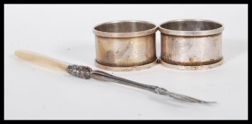 A pair of silver hallmarked napkin rings along wit