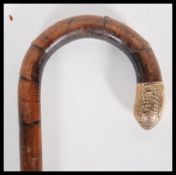 A 20th Century walking stick cane having crook han