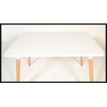 A contemporary white laminated and ash dining tabl