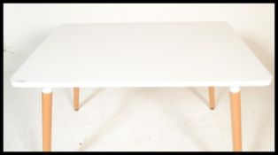 A contemporary white laminated and ash dining tabl