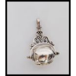 A silver ladies revolving 3 section locket pendant