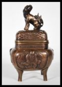 A Chinese bronze censer ding incense burner raised