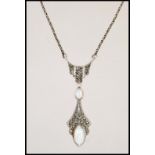 A silver and marcasite necklace pendant having two