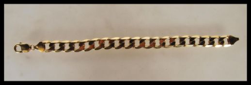 A stamped 375 9ct gold flat curb link bracelet wit