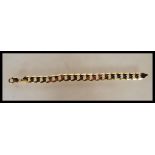 A stamped 375 9ct gold flat curb link bracelet wit