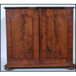 A VIctorian 19th century mahogany desk top specimen cabinet. Plinth base with bun feet to corners.