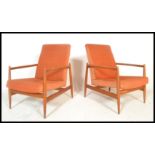 A pair of Danish style retro 20th Century open framed teak wood lounge / fireside armchairs each