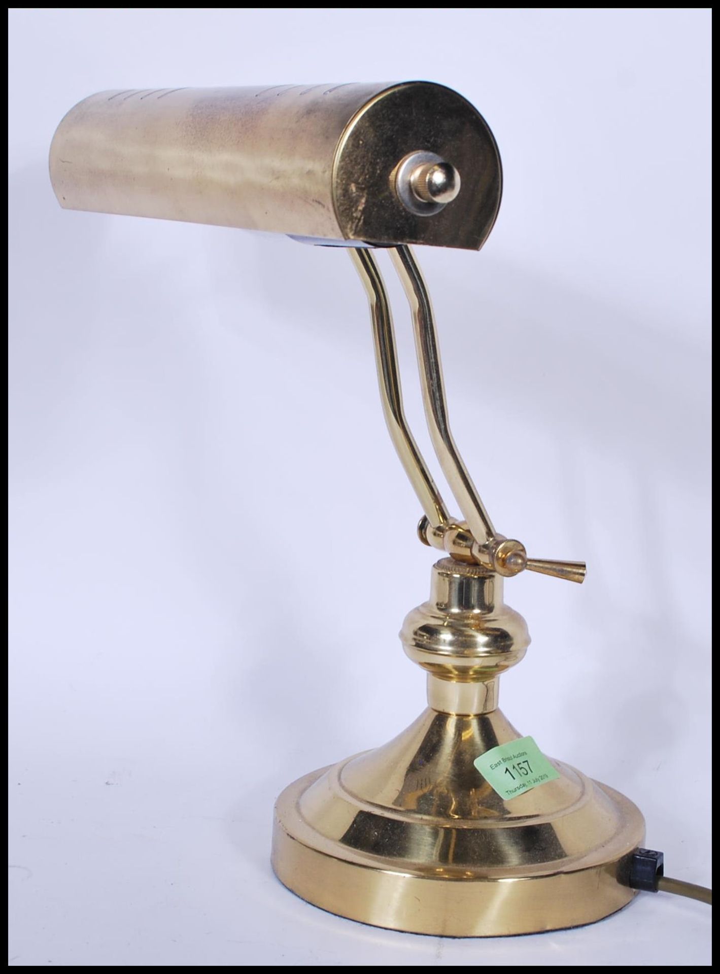 A vintage / retro 20th Century brass bankers desk lamp, having an adjustable brass shade raised on a