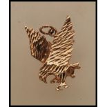 A 9ct gold pendant in the form of an eagle with en