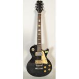A vintage style  American made Hondo six string electric guitar, having a black body with white
