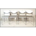 A set of eight panel stacking dining  chairs, the chairs panels having a silvered finish raised on