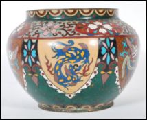 A 19th Century Chinese Cloisonne vase of squat from having panels depicting dragons and phoenix with