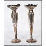 A pair of early 20th Century Art nouveau silver hallmarked spill vases of tapering form having