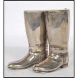 A pair of 20th Century silver plated drinks measures in the form of riding boots having raised