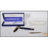 A cased Waterman fountain pen, the lidded pen having a blue marble finish with gilt metal