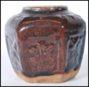 A Chinese monochrome hexagonal panelled ginger jar, moulded in relief with floral panels having a