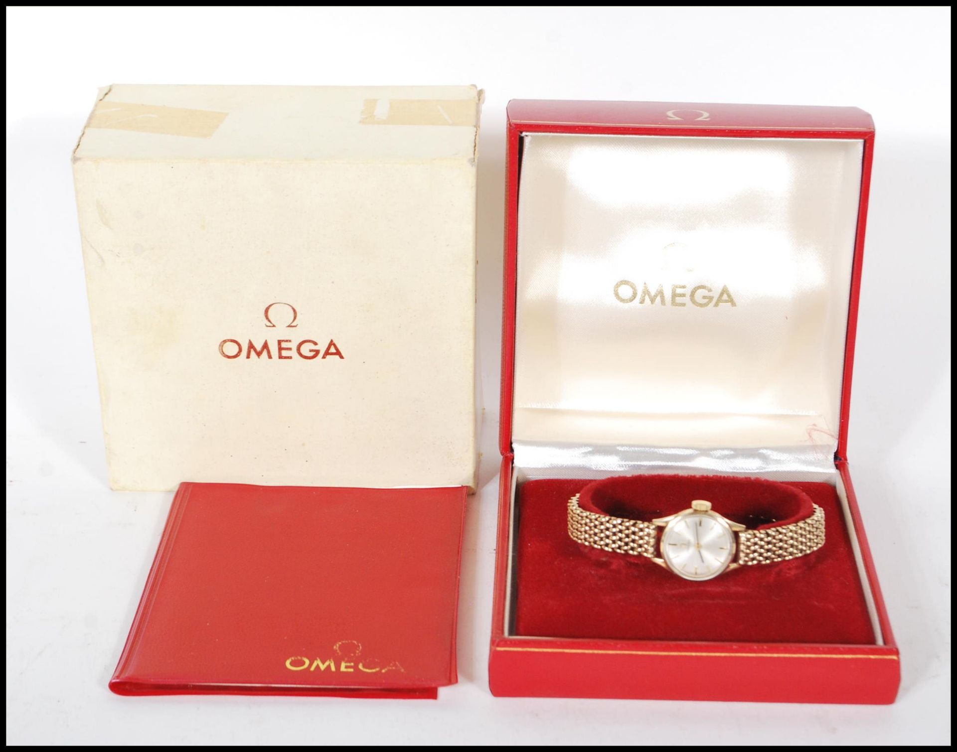 A vintage boxed Omega 9ct gold ladies cocktail watch set to a 9ct gold watch bracelet strap.