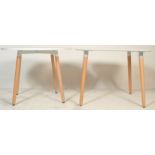 A contemporary white laminated and ash circular dining table. The table comprising of a laminated