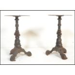 A pair of early 20th century garden / pub table of cast metal construction. Each base in the form of