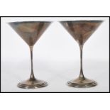 A pair of silver hallmarked cocktail, champagne, martini glasses, having shaped conical bowl with