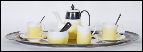 A early 20th Century childs tea service by George Jones, being two tone yellow and white in colour