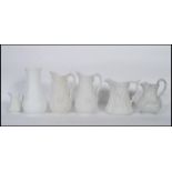 A collection of 20th century Portmeirion Parian ware jugs of graduating sizes, each cast in relief