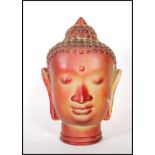 A vintage retro 20th Century red glass Buddha head featuring beaded headdress with moulded