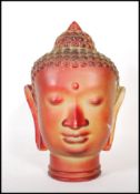 A vintage retro 20th Century red glass Buddha head featuring beaded headdress with moulded