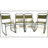 A set of four vintage mid 20th Century metal tubular stacking chairs, original canvas seat pads