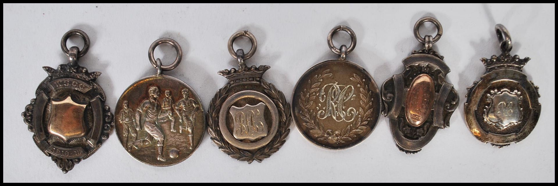 A collection of early 20th Century silver hallmarked sporting fob medals, two having gold plated