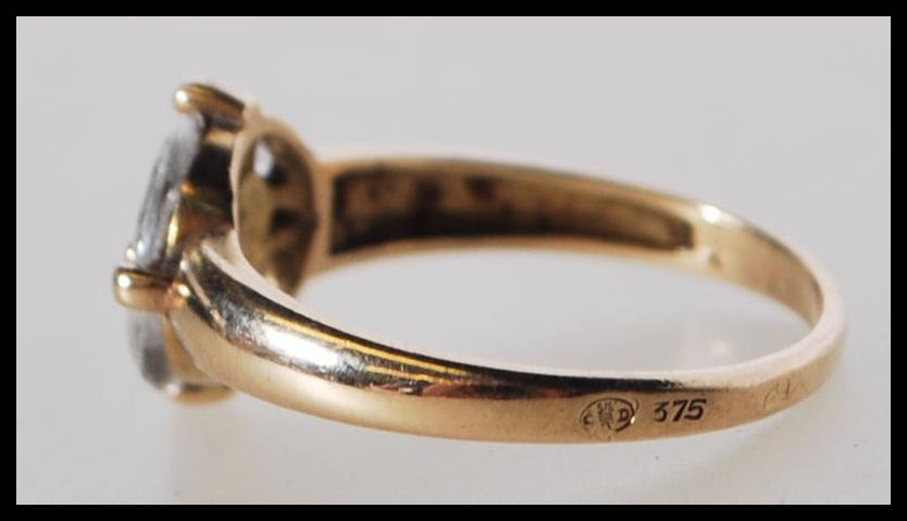 A stamped 375 9ct gold ring set with five white stones to the head. Weight 2.1g. Size O.5. - Image 5 of 5