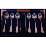 A cased set of 20th century silver hallmarked teaspoons and sugar tongs set complete in the original