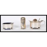 A silver hallmarked 3 piece condiment set comprising lidded and open pots, both with blue liners