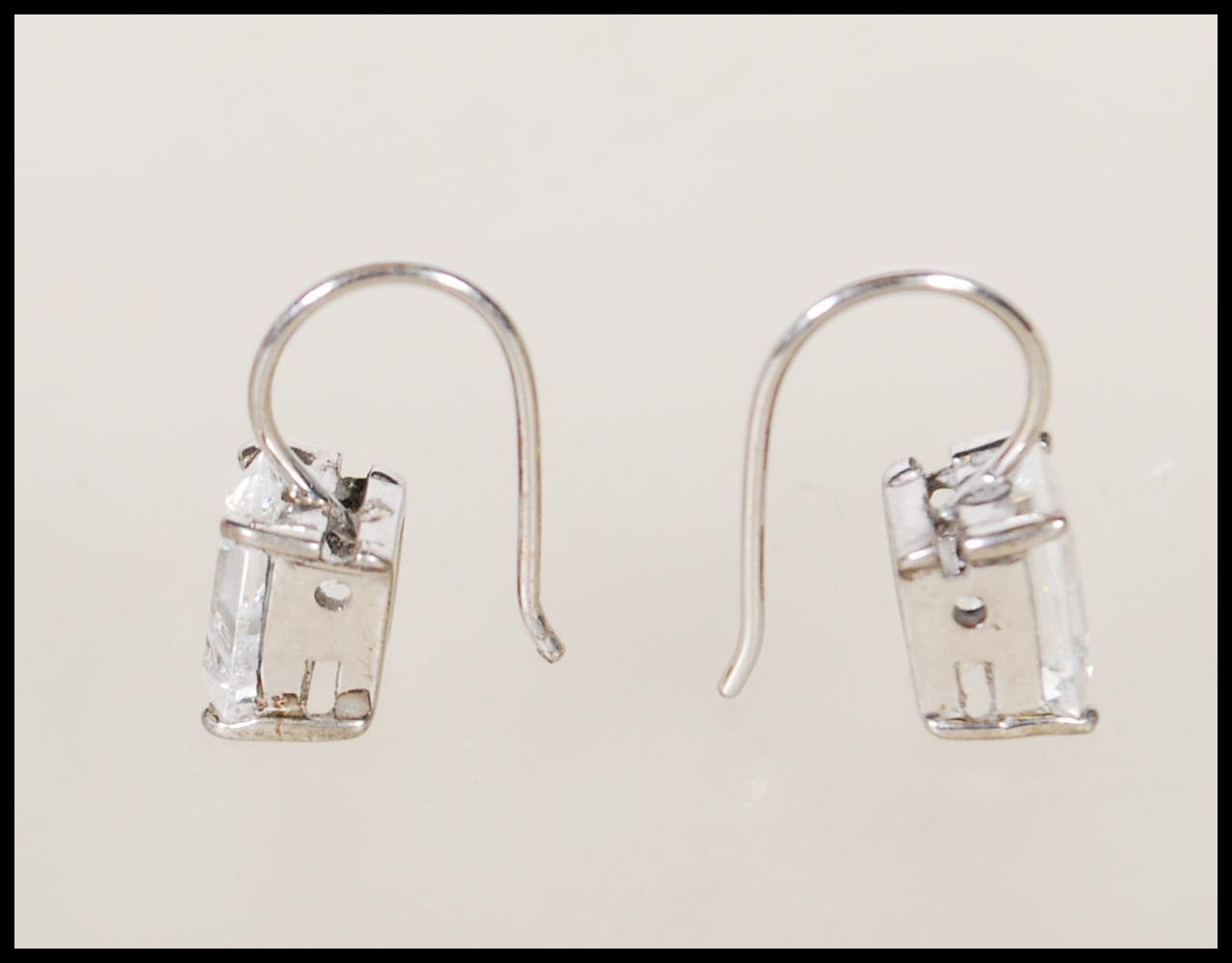 A pair of silver and emerald cut cz stone ladies earrings in claw mounts with hoop backs. Total - Image 2 of 3