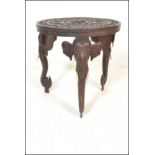 A late 19th / early 20th Century Anglo Indian highly carved circular tripod table supported by