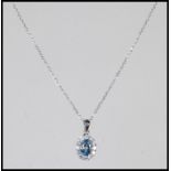 An 18ct white gold, aquamarine and diamond set necklace pendant set to a gold back chai. The central