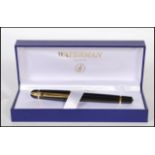 A cased Waterman ballpoint pen, the lidded pen having a black finish with gilt metal detailing in