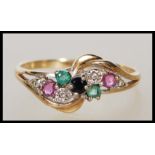 A hallmarked 9ct gold ring having a crossover design set with a cluster of round cut coloured stones