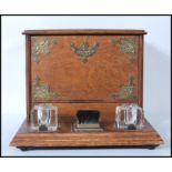 A 20th Century oak desk tidy having two glass inkwells to the base with brush between having