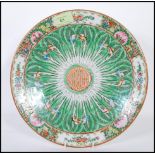 An early 20th Century Chinese export famille verte hand painted centrepiece plate having a floral