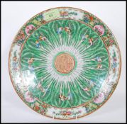 An early 20th Century Chinese export famille verte hand painted centrepiece plate having a floral